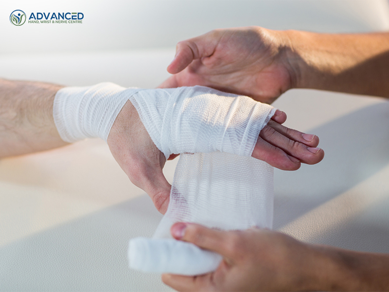 Doctor putting bandage on patient's hand