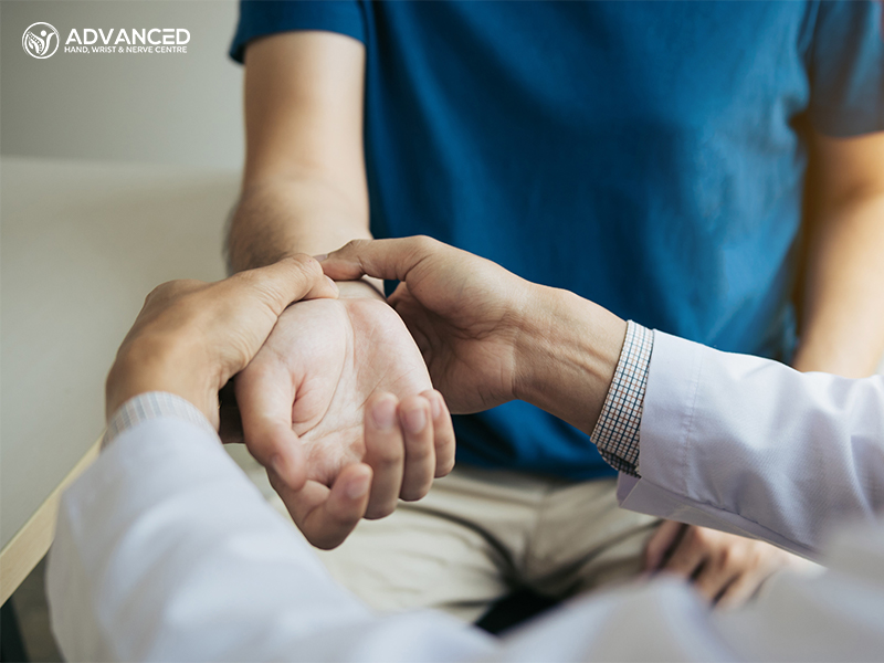 Physical therapist checks the patient wrist by pressing the wrist bone in clinic room
