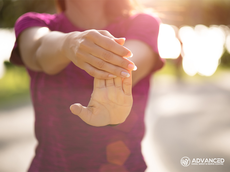 Woman Runner Stretching Hand Before Run In The Park