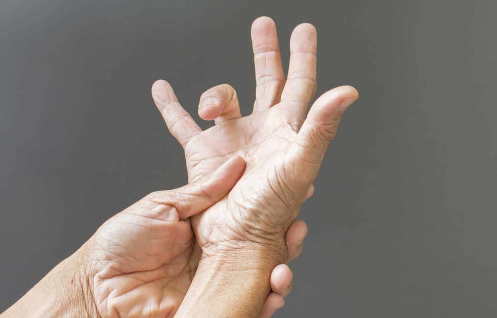 asian man experiencing Trigger Finger pain in Singapore
