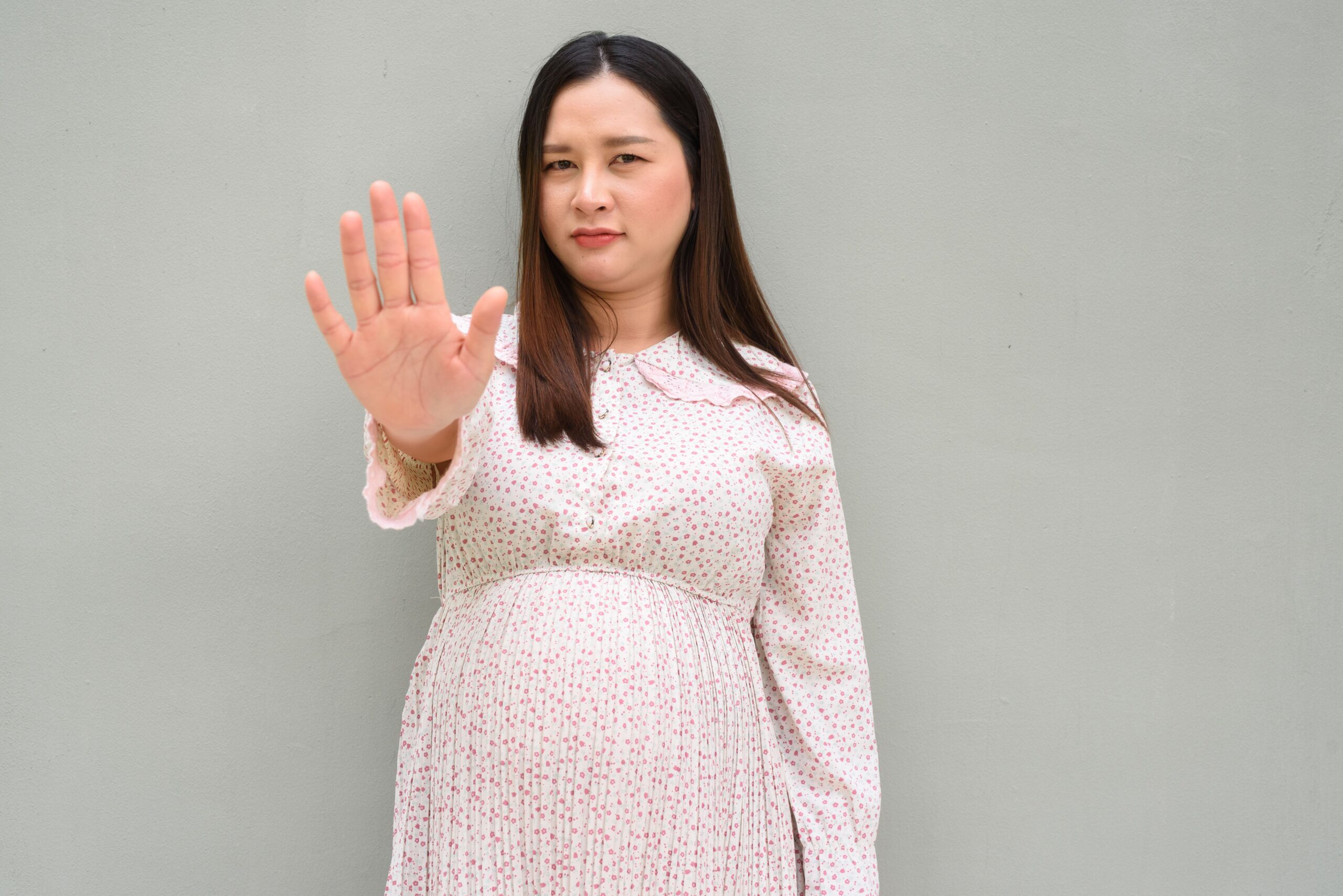 Image pregnant woman portrait against plain wall 2025 03 19 20 39 47 utc